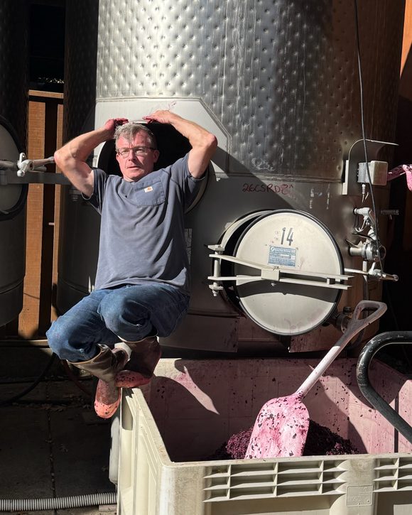 Cleaning out a fermentation tank in the Neal Family Vineyards cellar during the 2026 harvest